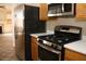 Modern kitchen featuring stainless steel appliances, wood cabinets, and white countertops at 254 Horizon Pointe Cir, Henderson, NV 89012