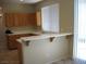 An open kitchen space with tile flooring, wooden cabinets, and a breakfast bar at 254 Horizon Pointe Cir, Henderson, NV 89012