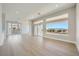 Bright open-concept living space with light wood flooring, large windows and view to mountains in background at 2904 Bow Bridge Dr, Las Vegas, NV 89134