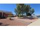 A backyard with mature shade trees, xeriscaping and plenty of space for outdoor activities at 2965 Palma Vista Cir, Las Vegas, NV 89169