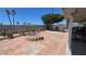 The spacious backyard features brick pavers, a charming fire pit, and lush greenery for outdoor enjoyment at 2965 Palma Vista Cir, Las Vegas, NV 89169