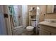Practical bathroom featuring a walk-in shower, toilet, vanity, and shelving unit at 2965 Palma Vista Cir, Las Vegas, NV 89169