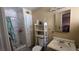 Functional bathroom with a shower, toilet, and vanity with storage shelving at 2965 Palma Vista Cir, Las Vegas, NV 89169