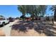 Image shows the property with mature shade trees and desert landscaping at 2965 Palma Vista Cir, Las Vegas, NV 89169