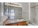 Well-lit bathroom featuring a vanity with a granite countertop and a large mirror reflecting the open doorway at 3318 N Decatur Blvd # 2103, Las Vegas, NV 89130