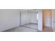 Carpeted bedroom with mirrored closet doors and a traditional closet door at 3318 N Decatur Blvd # 2103, Las Vegas, NV 89130