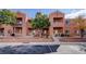 Exterior view of a multi-story building with balconies and stairs, surrounded by trees and landscaping at 3318 N Decatur Blvd # 2103, Las Vegas, NV 89130