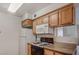 This modern kitchen features a range, a microwave, a refrigerator and wood cabinets at 3318 N Decatur Blvd # 2103, Las Vegas, NV 89130