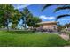 A neighborhood park with a grassy field, picnic tables under a shade structure, and mature trees at 3318 N Decatur Blvd # 2103, Las Vegas, NV 89130