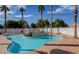 Community pool with a hot tub, lounge chairs, palm trees, and clear blue water at 3318 N Decatur Blvd # 2103, Las Vegas, NV 89130