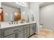 A stylish bathroom features a double sink vanity, an oversized mirror, and a toilet in its own room at 3337 Partridge Run St, Laughlin, NV 89029