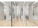 A long bathroom hallway with mirrored closet doors features dual vanities and a shower over tub at 3337 Partridge Run St, Laughlin, NV 89029