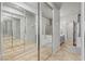 A spacious bathroom with double mirrored closet doors features dual vanities and a shower over tub at 3337 Partridge Run St, Laughlin, NV 89029