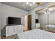 Comfortable bedroom featuring ceiling fan, mirrored closet doors, and a TV sitting atop a dresser at 3337 Partridge Run St, Laughlin, NV 89029
