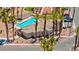 Aerial view of a community pool and clubhouse surrounded by tall palm trees in a residential neighborhood at 3337 Partridge Run St, Laughlin, NV 89029