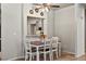 Bright dining area with a view to the kitchen, a ceiling fan, and seating for four at 3337 Partridge Run St, Laughlin, NV 89029