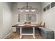 Bright dining area features a custom wooden table, stylish light fixture, and built-in bench seating at 3337 Partridge Run St, Laughlin, NV 89029