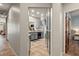 Hallway leading to the open kitchen and dining area, featuring gray cabinets and black appliances at 3337 Partridge Run St, Laughlin, NV 89029