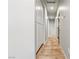 A long hallway with tile flooring has recessed lighting and white storage cabinets down one side at 3337 Partridge Run St, Laughlin, NV 89029