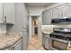 Kitchen showcases granite countertops, gray cabinets, and modern appliances at 3337 Partridge Run St, Laughlin, NV 89029