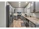 Modern kitchen features stainless steel appliances, gray cabinets, and granite countertops at 3337 Partridge Run St, Laughlin, NV 89029