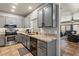 Well-lit kitchen boasts stainless appliances, gray cabinetry, and granite countertops with an open floorplan at 3337 Partridge Run St, Laughlin, NV 89029