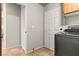 Laundry room features a new washer and dryer units, a white door, and a wooden cabinet at 3337 Partridge Run St, Laughlin, NV 89029