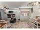 Spacious living room with a decorative fireplace, ceiling fans and dining area at 3337 Partridge Run St, Laughlin, NV 89029