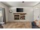 Relaxing living area boasting a fireplace, tiled flooring, and natural light from adjacent windows at 3337 Partridge Run St, Laughlin, NV 89029