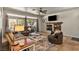 Comfortable living room featuring a tiled fireplace, neutral decor, and access to an outdoor patio at 3337 Partridge Run St, Laughlin, NV 89029