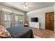 A bright main bedroom features a ceiling fan, a mounted TV, and sliding door access to an outdoor seating area at 3337 Partridge Run St, Laughlin, NV 89029