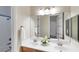 Bathroom featuring a double vanity, a large mirror, and a bathtub with a shower at 3540 Wisdom Ct, Las Vegas, NV 89120