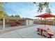 Spacious covered patio with picnic tables and string lights, perfect for outdoor dining and entertaining at 3540 Wisdom Ct, Las Vegas, NV 89120
