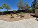Backyard featuring a patio, rock garden, and decorative plants surrounded by a fence at 4814 Regalo Bello St, Las Vegas, NV 89135