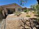 Backyard featuring a patio, rock garden, and decorative plants surrounded by a fence at 4814 Regalo Bello St, Las Vegas, NV 89135