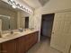 Bathroom features double sinks, a large mirror, and an enclosed shower at 4814 Regalo Bello St, Las Vegas, NV 89135