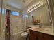 Bathroom with tub, shower, vanity with large mirror, and decorative lighting fixtures at 4814 Regalo Bello St, Las Vegas, NV 89135