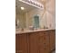 Bathroom features a vanity with double sinks, bright lights and a large mirror at 4814 Regalo Bello St, Las Vegas, NV 89135