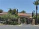 Gated community entrance with lush landscaping, tiled roof and desert mountain views at 4814 Regalo Bello St, Las Vegas, NV 89135