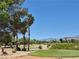 Picturesque golf course view showcasing manicured greens, palm trees, and mountain views in the background at 4814 Regalo Bello St, Las Vegas, NV 89135