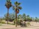 Scenic view of a golf course with palm trees, lush greenery, and beautiful landscaping around a building at 4814 Regalo Bello St, Las Vegas, NV 89135