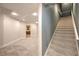 A spacious basement area with tile and carpet flooring and a staircase leading to the upper floors at 5110 N Valadez St, Las Vegas, NV 89149