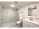 Bright bathroom with a glass enclosed shower, white cabinets, modern sink and mirror at 5110 N Valadez St, Las Vegas, NV 89149
