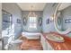 Bright bathroom with a vintage style claw foot tub, elegant chandelier and lots of natural light at 5110 N Valadez St, Las Vegas, NV 89149