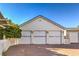 Detached three-car garage with white siding and brick driveway at 5110 N Valadez St, Las Vegas, NV 89149