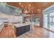 Gourmet kitchen with brick archway, large island, custom cabinets, and hardwood floors at 5110 N Valadez St, Las Vegas, NV 89149