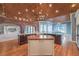 Gourmet kitchen featuring dual islands, brick archway, and wood-paneled ceiling at 5110 N Valadez St, Las Vegas, NV 89149