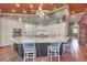 Bright kitchen with a large granite island, custom cabinetry, and wood ceiling at 5110 N Valadez St, Las Vegas, NV 89149