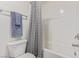 Bathroom featuring a white tiled shower and a neutral-toned shower curtain at 527 Clearsable Ave, Henderson, NV 89044