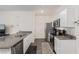 Bright kitchen featuring stainless appliances, granite counters, and white cabinetry at 527 Clearsable Ave, Henderson, NV 89044